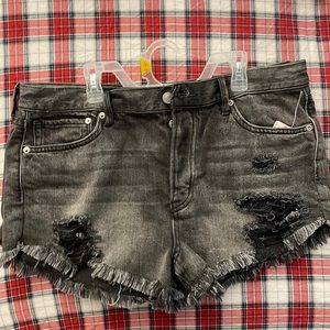 Free people frayed Jean shorts in a faded black with deconstructed spots